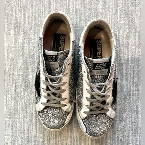 Size 7 glitter golden goose. Wear and tear but could replace rubber on front